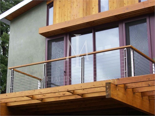<p>This is a surface mounted stainless steel cable rail constructed with Type 304 Alloy stainless steel 1/2″ x 2″ soild flat bars. This double vertical post system helps achieve an asian modern look. All the cable rails we manufacture that incorporate wood tops/caps also require a metal top rail combined to allow proper cable tension</p>

