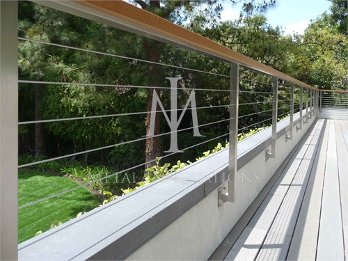 <p>This is a side mounted stainless steel cable rail that has a Ipe wood cap. It was mounted on the inside of the deck so that it prevents children from stepping on pony wall.</p>
<p>
